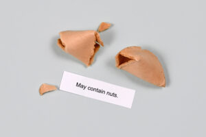 Food allergy concept. Fortune cookie with text ‘may contain nuts